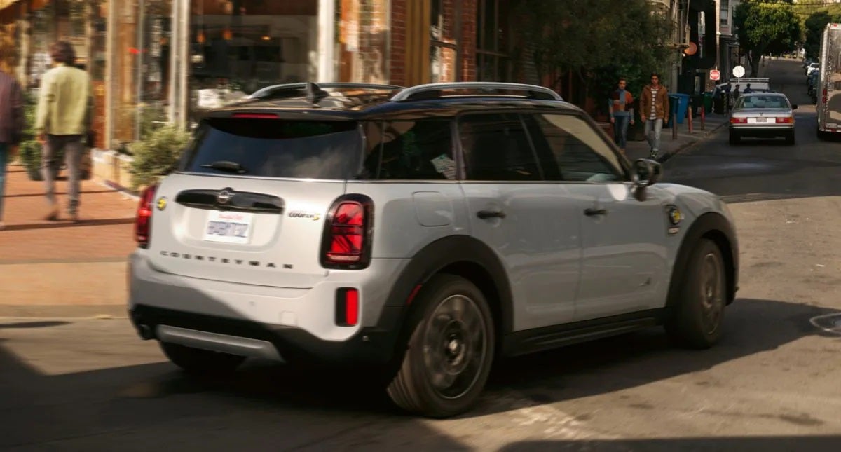 The MINI Cooper SE Countryman PHEV turning a corner in the city. MINI of Edison in Edison NJ