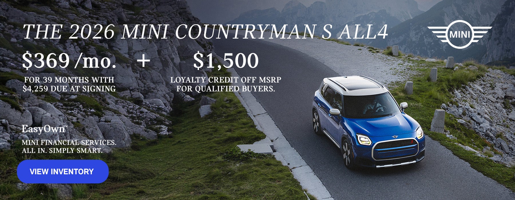 Front view of a blue MINI Countryman driving on a mountainous road.