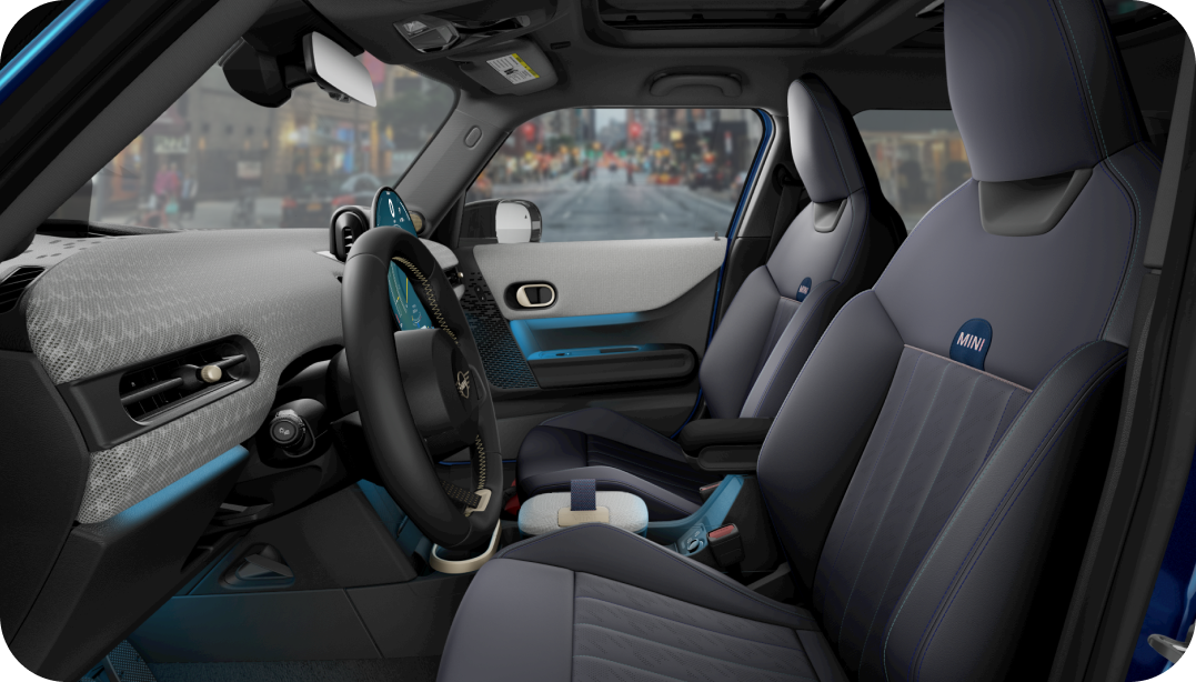 The view of the inside of the MINI Cooper S 4 Door taken from the driver’s side, showcasing the front Sports Seats and dashboard.