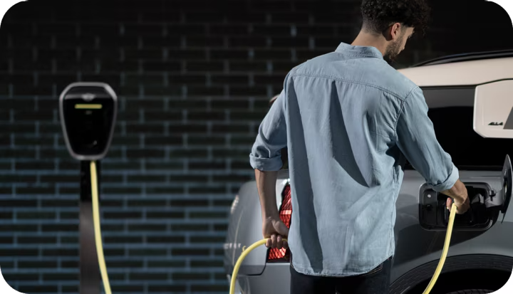 A man charges his MINI Countryman SE ALL4.