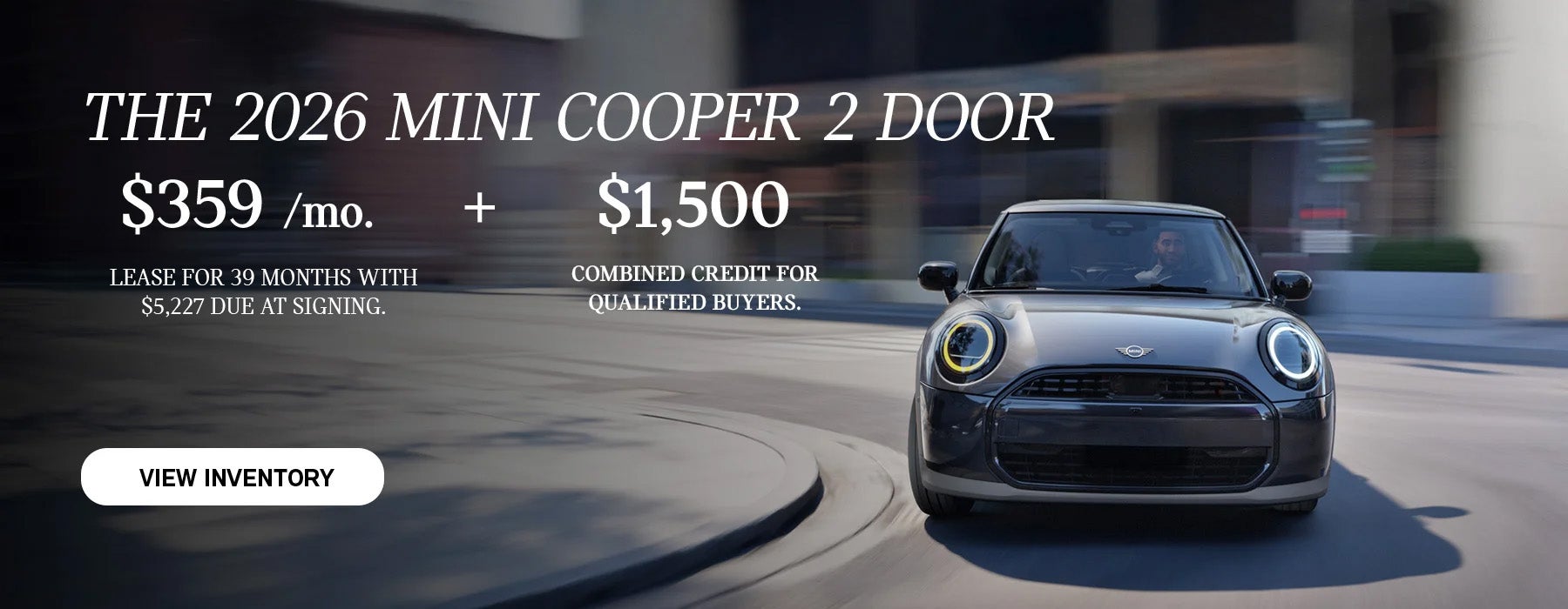 Front view of man driving grey MINI 2Door down a curved city