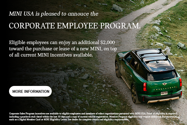 Back view of green countryman driving up hill.