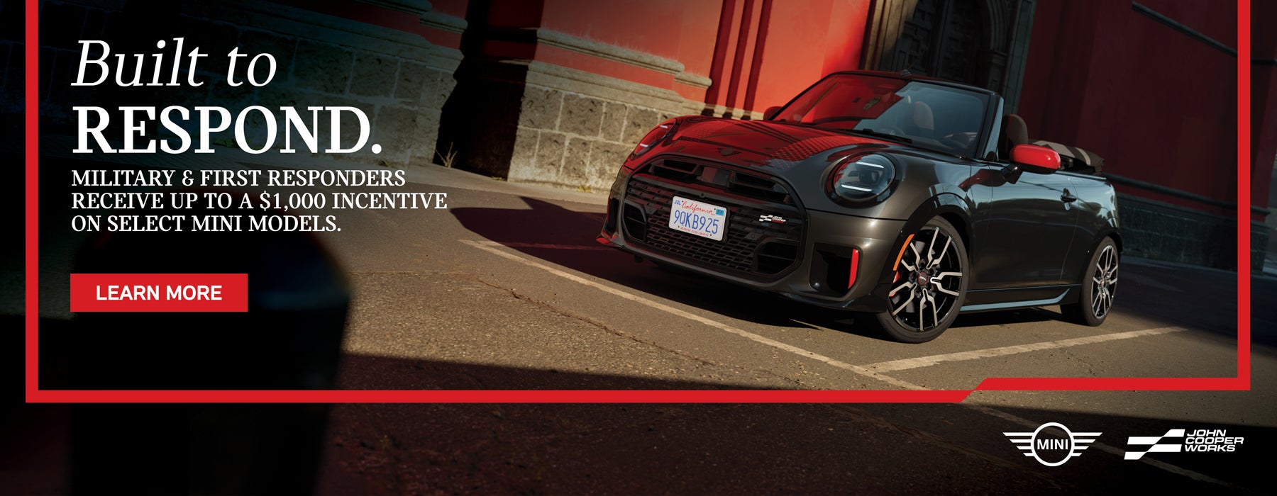 Black JCW Convertible parked by a building.