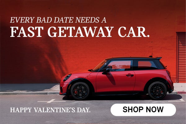 side view of red MINI infront of red wall.